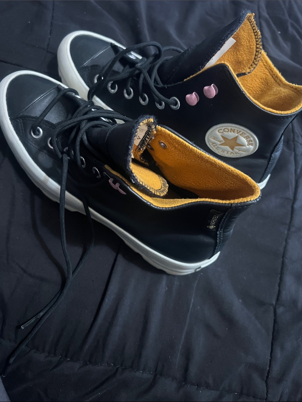 Converse women’s Black High-Top Sneakers with Pink Accents